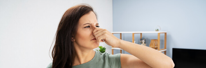 Woman Covering Her Nose From Bad Smell