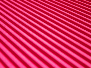 Background surface made of red, crimson pape rwith diagonal stripes