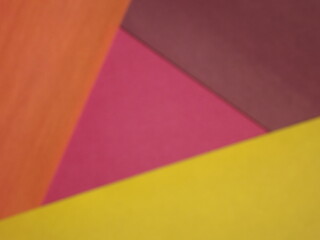 Background surface made of green, red, crimson, orange and yellow paper