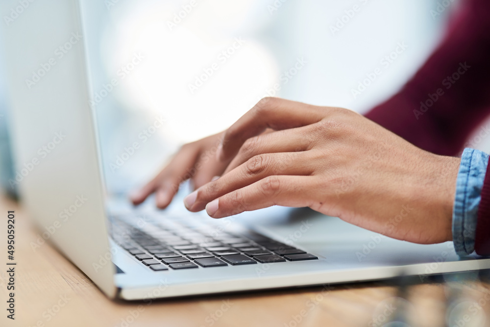 Poster hes a 70 wpm kind of guy. shot of an unidentifiable businessman using his laptop in his office.