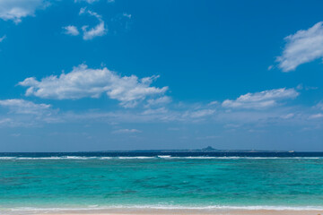 Fototapeta na wymiar 瀬底ビーチから伊江島を望む海と空