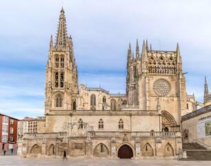 Fototapeta premium Burgos Cathedral with people and tourists walking past in the square next to the Cathedral of Saint Mary