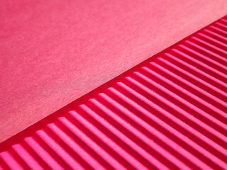 Background surface made of red, crimson pape rwith diagonal stripes