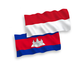 National vector fabric wave flags of Indonesia and Kingdom of Cambodia isolated on white background. 1 to 2 proportion.