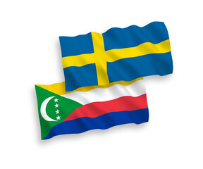 National vector fabric wave flags of Sweden and Union of the Comoros isolated on white background. 1 to 2 proportion.