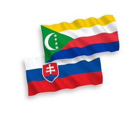 National vector fabric wave flags of Slovakia and Union of the Comoros isolated on white background. 1 to 2 proportion.