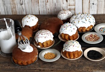 Pre holiday chores. Homemade Easter pastries with festive sprinkles for baking are displayed on a wooden background.