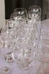 Girl waiter pours champagne into glasses. Canapes preparation of a buffet table with alcohol and fruit for a party for guests. Free space for text