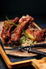 Delicious barbecued ribs seasoned with a spicy sauce. Food still life. Close-up. Vertical shot