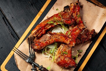 Delicious barbecued ribs seasoned with a spicy sauce. Food still life. Close-up. Top view