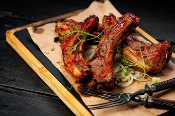 Delicious barbecued ribs seasoned with a spicy sauce. Food still life. Close-up. Copy space
