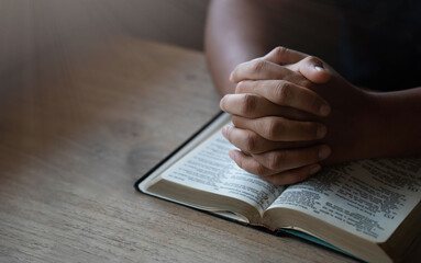 prayer for blessings to god Christian life Man sitting and praying for God's blessings for a better life Human hands praying to God with scriptures on the windowsill. with the light shining down