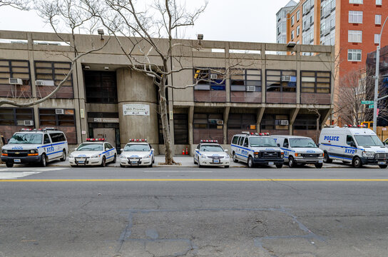 NYPD Different New York Police Department cars and trucks and van parked  next to each other at a police station in Harlem next to the street, New  York City, during winter day,
