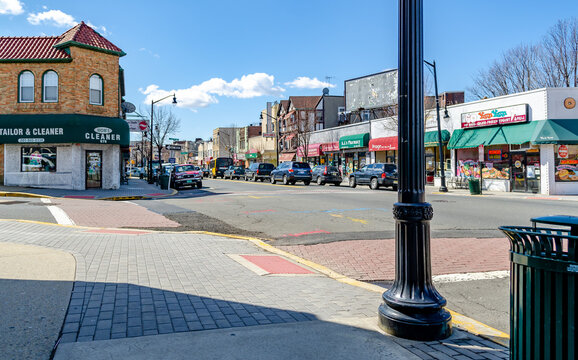 Different grocery and Retail Stores at Center of the City near Cliffside Park, New Jersey, during a sunny winter day, view from the other side of the street, cars parked in front of the stores, horizo