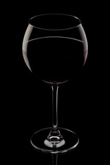 glass of red wine isolated on black