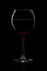 glass of red wine isolated on black