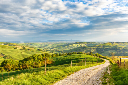 Dirt road into the valley in a rural Italian landscape