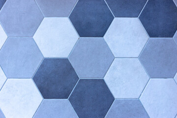 Gray and black tiles on the floor. Hexagon patterns.