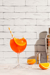 Glass of cold Aperol spritz cocktail.