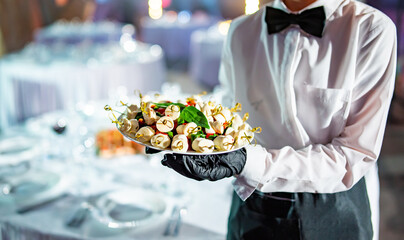 waiter holds plate with food. Restaurant service. buffet or catering.