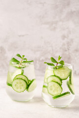 Fresh infused cucumber water on a light background