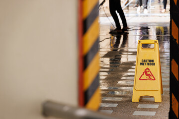 caution wet floor sign on public footpath.