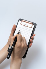 To-do list and fountain pen on a white background