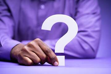 Confused Man Holding Question Mark