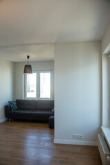 Dark blue sofa with blue and turquoise cushion in a white room
