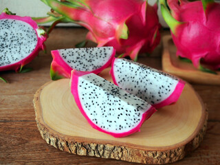 Dragon fruit or pitaya on rustic wooden cutting board