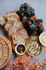 Delicious homemade pastry meal. Bread Platter with Garlic Butter Infused Olive Oil and North Atlantic Sardines.