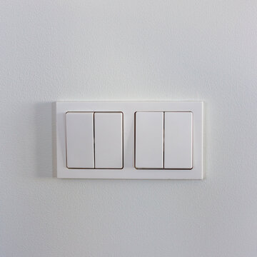 White light switches on a white wall