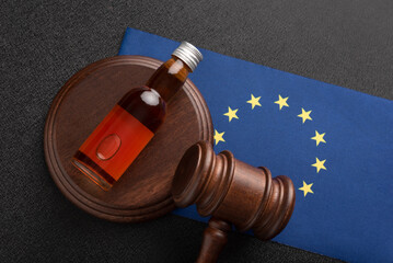 Law hammer, alcohol and EU flag. Legal problems with alcohol in European Union. Alcohol and crimes...