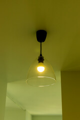 Ceiling lamp in the apartment in yellow light