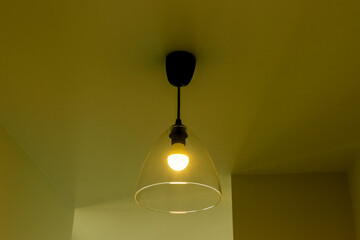 Ceiling lamp in the apartment in yellow light