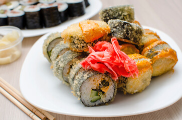 Fried rolls with ginger on a plate, close-up.