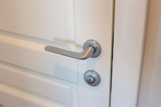 White Door And Silver Doorknob In The Apartment