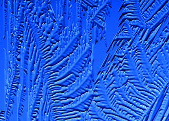 Drawings of ice on blue glass.