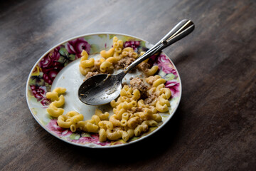 Half-eaten homemade pasta with cutlet