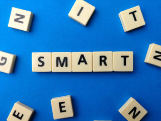 Top view toys word with text SMART on a blue background.