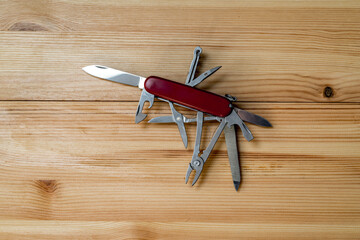 multipurpose pocket knife on wooden table
