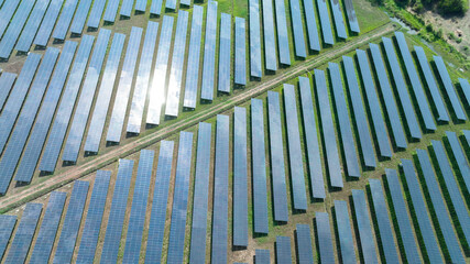 Aerial top view of solar panels or solar cells farm, renewable energy source. Ecotechnology for electric power in the industry.