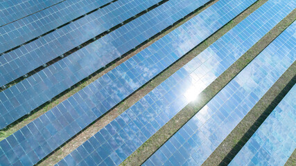 Aerial top view of solar panels or solar cells farm, renewable energy source. Ecotechnology for electric power in the industry.