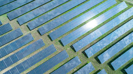 Aerial top view of solar panels or solar cells farm, renewable energy source. Ecotechnology for electric power in the industry.