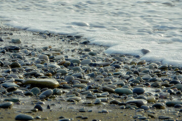 Sea water with foam and waves, natural background photo.