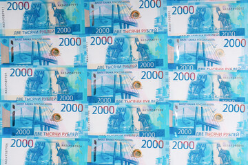 Background made of new russian money banknotes of two thousand roubles. Success in business, finance, wealth concept