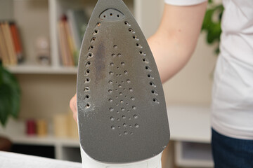 Damaged sole of the iron, brown stains and traces of burning with smoke and steam. Improper...