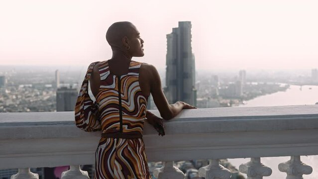 Fashion Model Posing In Swirled Pattern Clothes Looking Over City