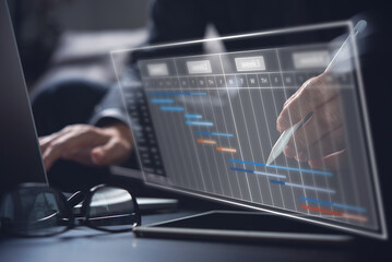 Project manager working and update tasks with milestones progress planning. Businessman using laptop computer with Gantt chart scheduling