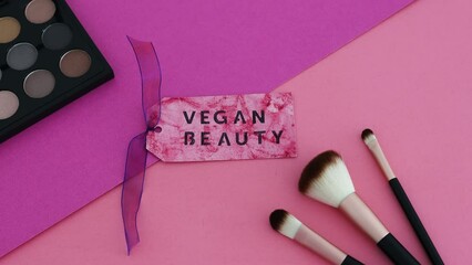cruelty free beauty products, Vegan Beauty label next to make-up brushes and eyeshadow palette